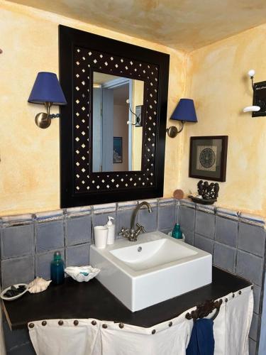 a bathroom with a sink and a mirror at Serifos house in Serifos Chora