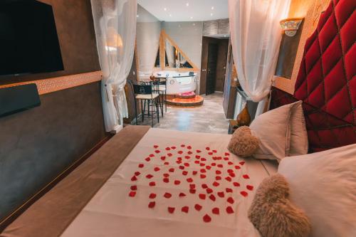 a bedroom with a bed with red hearts on it at Le Love Spa in Lyon