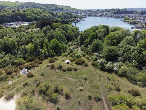 an aerial view of an island with a river at Stones and Stars Boutique Glamping in Radford Quarry in Plymouth