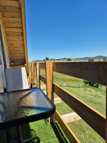 a table on a balcony with a view of a field at Durmitor Viewpoint in Žabljak
