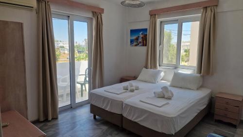 a bedroom with a bed with two towels on it at Kaloxenia in Kardamaina