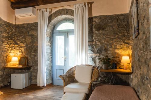 a living room with a chair and a window at Collina Blu in Orvieto