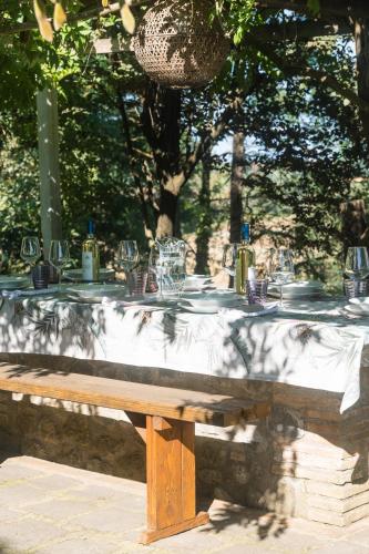 a table with glasses and wine bottles on top of it at Collina Blu in Orvieto