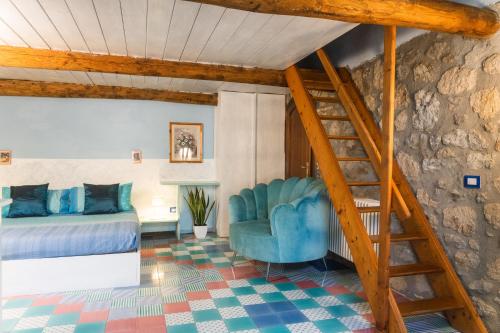 a bedroom with a blue bed and a staircase at Collina Blu in Orvieto