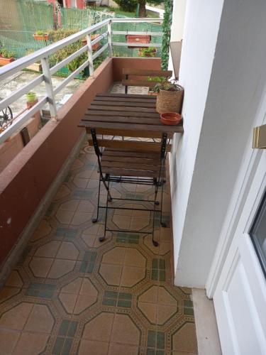a balcony with a table and a bench on a floor at Apartamentos Rovi in A Coruña