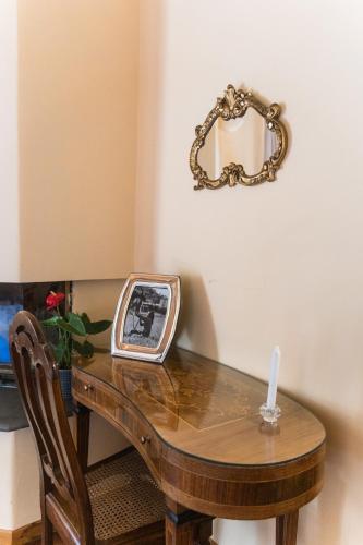 a table with a candle and a mirror on a wall at Collina Blu in Orvieto