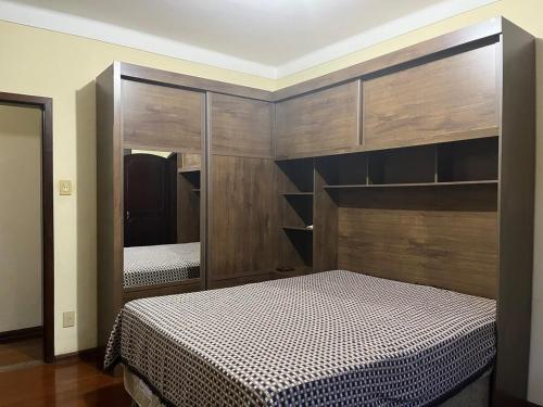 a bedroom with two beds and a large mirror at Casa completa em São João del-Rei in São João del Rei