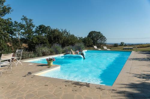 a woman is in a swimming pool at Collina Blu in Orvieto