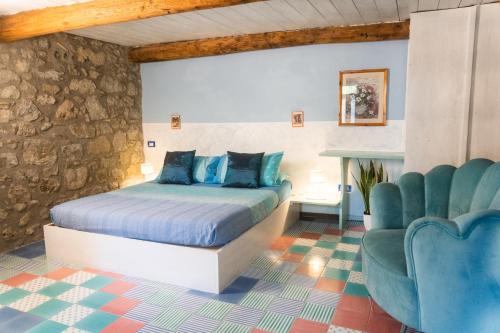 a bedroom with a bed and a chair at Collina Blu in Orvieto