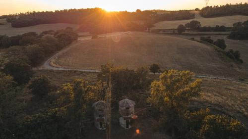 a large field with the sunset in the background at Collina Blu in Orvieto