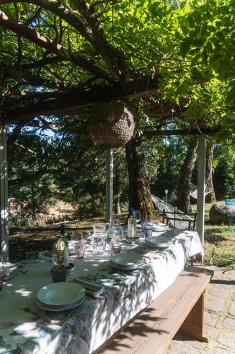 a table with plates and wine glasses on it at Collina Blu in Orvieto