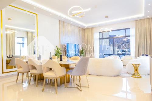 a dining room with a table and chairs at Bloomfields 4 Pluse Maid Royal Al Dana Villas in Fujairah