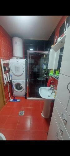 a bathroom with a shower and a toilet and a sink at Nikolas apartment in Mitrovica
