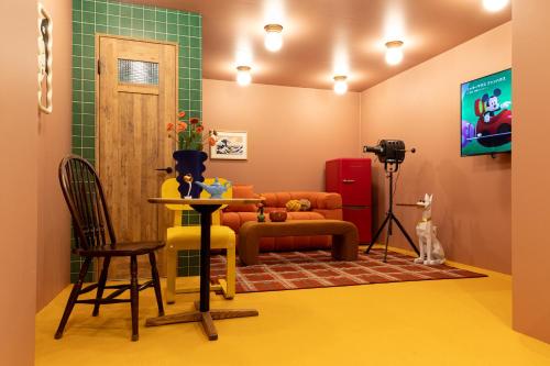 a living room with a tv and a table and chairs at Private house 100sqm with bicycles Disney 30min in Tokyo