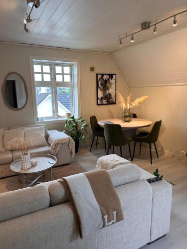 a living room with a couch and a table at Cozy top floor apartament in Stavanger
