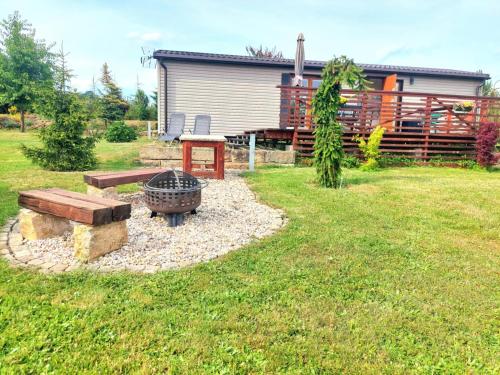 a backyard with a fire pit and a picnic table at Ubytování na vsi in Dvůr Králové nad Labem