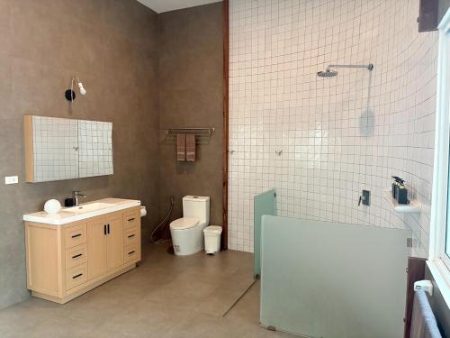 a bathroom with a sink and a shower and a toilet at Tropical Garden Luxury Villa, Koh Phangan in Koh Phangan