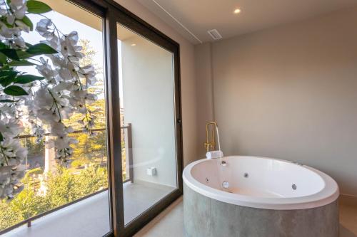 a bath tub in a bathroom with a large window at Reina Victoria La Plaza 2 in Alicante