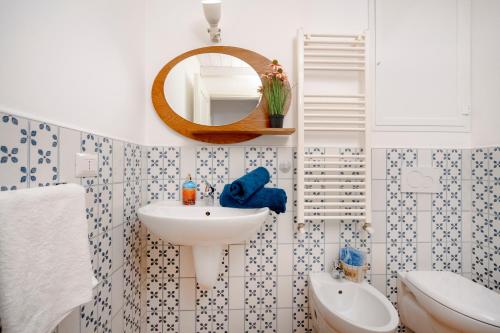 a bathroom with a sink and a mirror at Martini Holiday's house in Altamura
