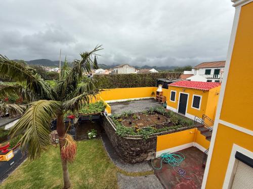 an aerial view of a house with a garden at Golden Mermaid Villa, Big Home Amenities - Small Hotel Room Price in Ribeira Grande