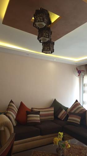 a living room with a couch with pillows on it at Time Off in Alexandria