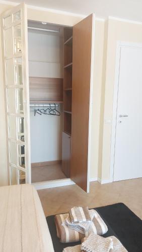 a bedroom with a closet with two towels on the floor at Cas'Ale ai Castelli Romani in Monte Compatri