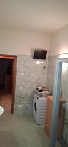 a bathroom with a sink and a tv on the wall at Locanda San Marco in Torri del Benaco