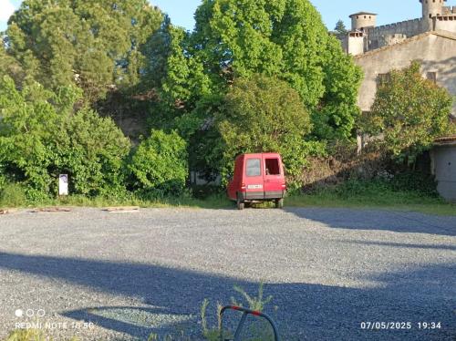 a red van parked in front of a castle at Les Bellevue Cité Trivalle "3 Apartments, 1 with Terrace & Private Parking, Aircon, WiFi, 500m from Cité, free public car park 200m" in Carcassonne