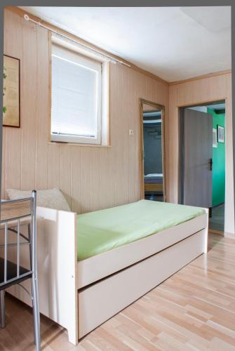 a small bedroom with a bed and a window at Pura Vida in Zaječí