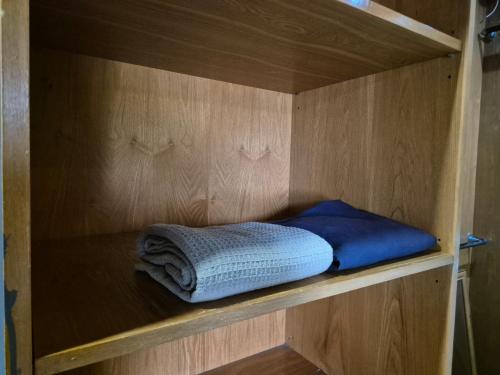 a wooden cabinet with two towels on a shelf at 13pax BAYU EXECUTIVE SUITE 3R2B, SEASIDE, ROOFTOP BBQ, WATERSPORT, Pool, Wifi, 50"TV in Port Dickson