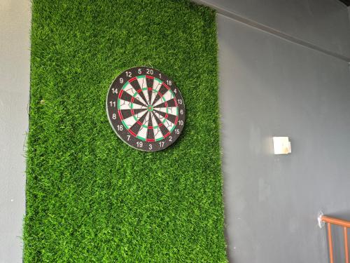a dart board on a wall with green grass at 13pax BAYU EXECUTIVE SUITE 3R2B, SEASIDE, ROOFTOP BBQ, WATERSPORT, Pool, Wifi, 50"TV in Port Dickson