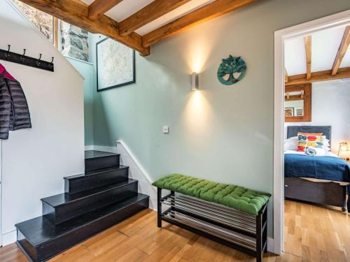a bedroom with a staircase and a bed in a room at 2 bed in Arthog 66611 in Arthog