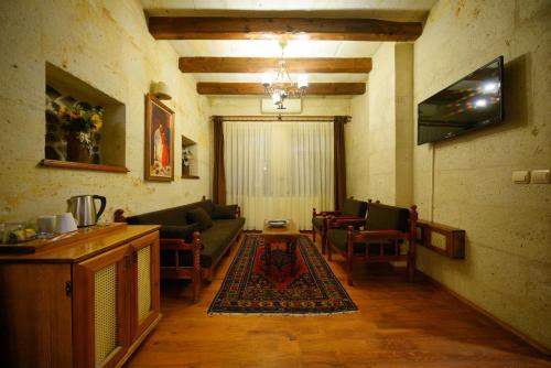 a living room with a couch and a table at Harman Cave Hotel in Goreme