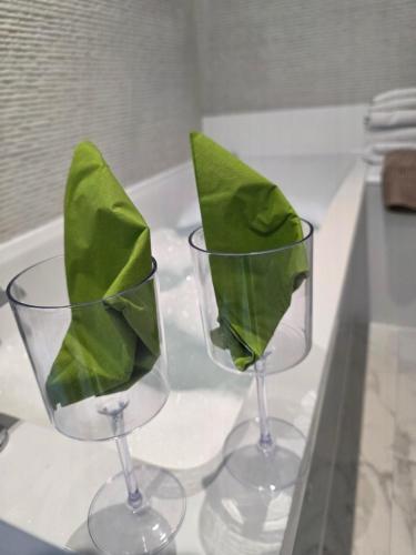 two wine glasses with green leaves in them on a counter at Musselburgh Links B&B in Musselburgh