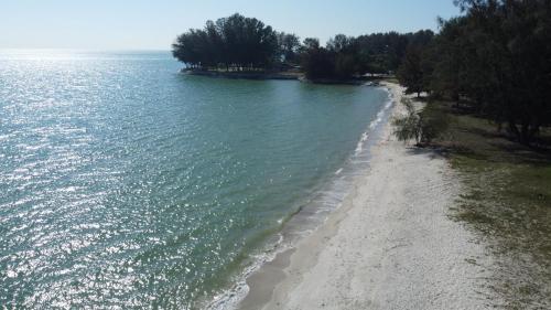 an aerial view of a beach next to the water at 13pax BAYU EXECUTIVE SUITE 3R2B, SEASIDE, ROOFTOP BBQ, WATERSPORT, Pool, Wifi, 50"TV in Port Dickson