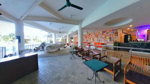 a restaurant with a bar with chairs and a table at 13pax BAYU EXECUTIVE SUITE 3R2B, SEASIDE, ROOFTOP BBQ, WATERSPORT, Pool, Wifi, 50"TV in Port Dickson