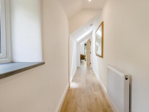 a hallway of a house with white walls and wooden floors at 4 Bed in Old Churchstoke 91498 in Church Stoke