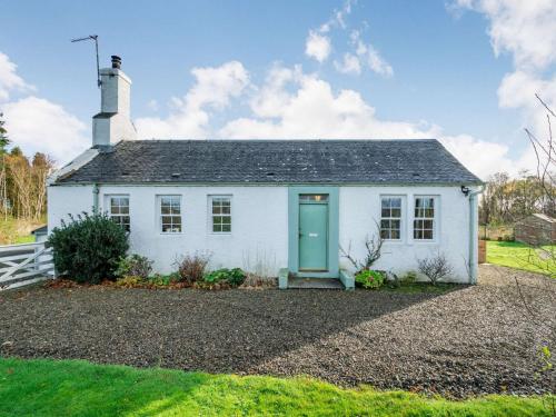 a white house with a green door at 2 Bed in Ayr 90039 in Ayr