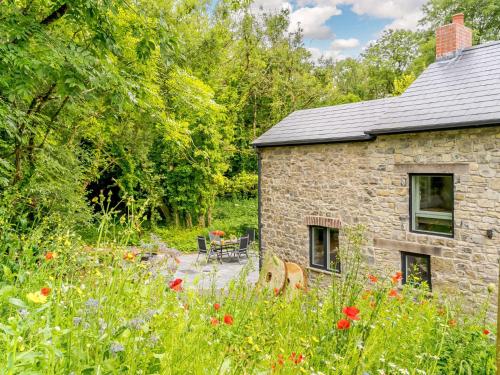 a stone house with a garden and flowers at 2 bed in Cowbridge 88000 in Llandow