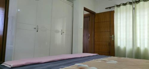a bedroom with a bed with a mirror and a door at ABS peace home in Burhānilkantha