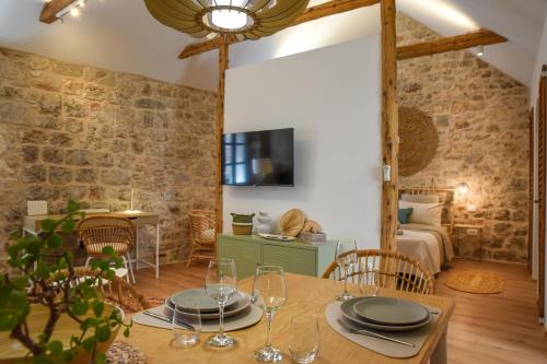 una sala da pranzo con tavolo e una camera da letto di "Historic Stone Loft" - ZF Stari Grad a Stari Grad (Cittavecchia)