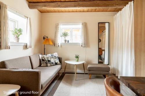 a living room with a couch and a table at Akaciegaarden Bed & Breakfast in Hårlev