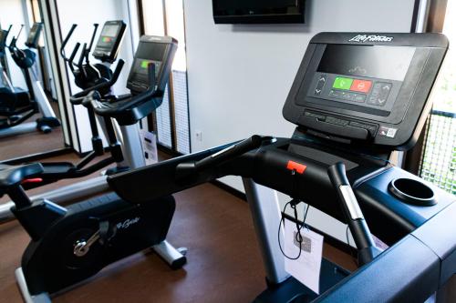 a gym with several exercise bikes and a monitor on a treadmill at Pacoche Murcia in Murcia