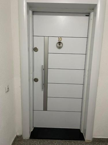 a white door with a number on it at Bluberry Apartment in Pristina