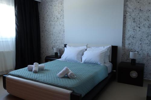a bedroom with a bed with towels on it at Kallithea View in Prasás