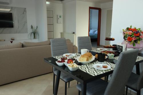 a table with food on it in a living room at Kallithea View in Prasás