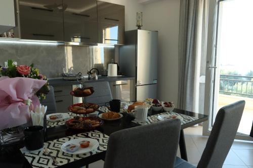 a kitchen with a table with food on it at Kallithea View in Prasás