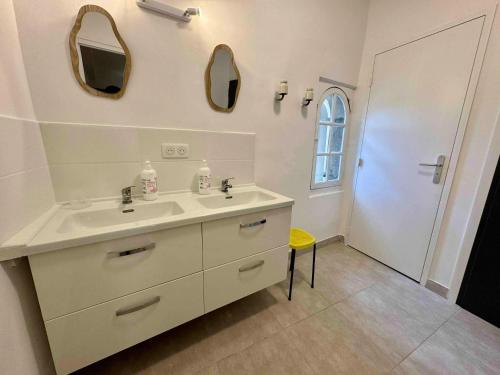 a white bathroom with a sink and two mirrors at Appartement spacieux à Laure-Minervois avec piscine in Laure-Minervois