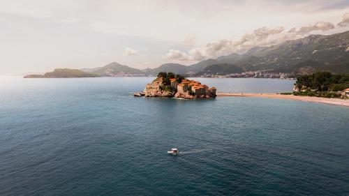 a small island in the middle of a body of water at Suite Apartment Sveti Stefan in Sveti Stefan
