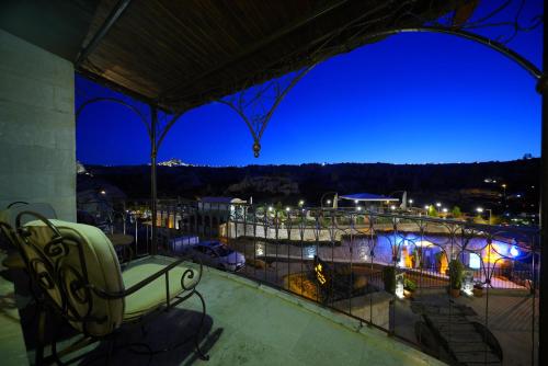 a balcony with a view of a city at night at Harman Cave Hotel in Goreme